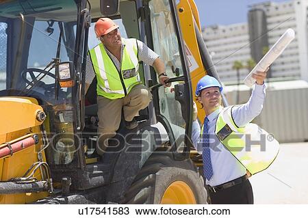 Stock Image - Architect talking to a building worker. Fotosearch