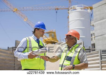 Architect talking to a building worker View Large Photo Image Stock Photo - Architect talking to a building worker. Fotosearch