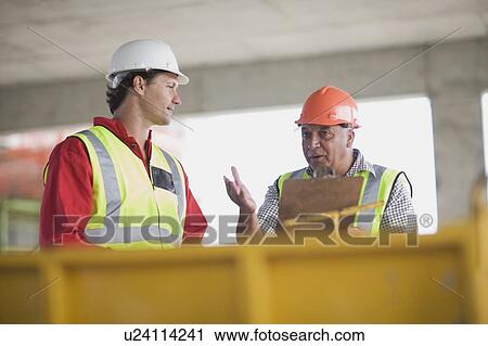 Architect talking to building worker View Large Photo Image Stock Image - Architect talking to building worker. Fotosearch