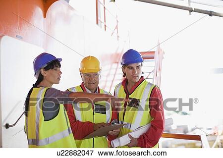 Architects and builders at work View Large Photo Image Stock Photo - Architects and builders at work. Fotosearch