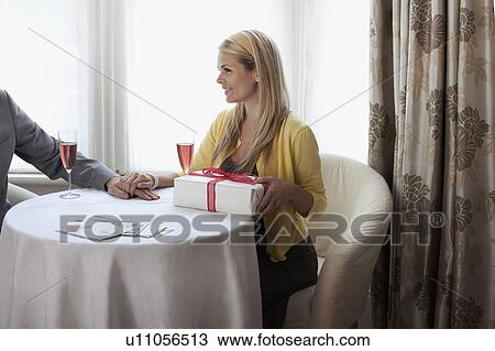 Attractive young wife with gift View Large Photo Image Stock Image - Attractive young wife with gift. Fotosearch