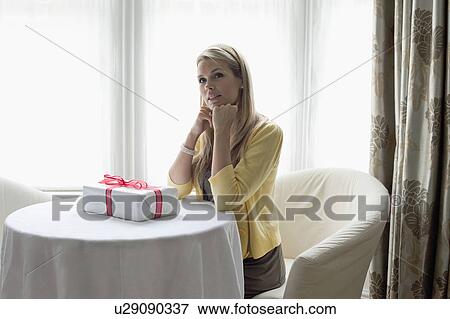 Attractive young woman with gift box View Large Photo Image Stock Photo - Attractive young woman with gift box. Fotosearch