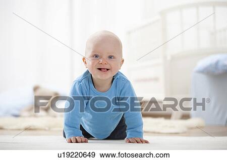 Baby boy crawling on carpet View Large Photo Image Stock Photo - Baby boy crawling on carpet. Fotosearch