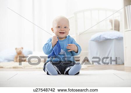 Baby boy playing with soft toy View Large Photo Image Stock Image - Baby boy playing with soft toy. Fotosearch