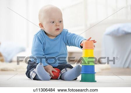 Baby boy playing with stacking cups View Large Photo Image Picture - Baby boy playing with stacking cups. Fotosearch