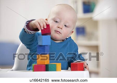 Baby boy playing with toy blocks View Large Photo Image Stock Photography - Baby boy playing with toy blocks. Fotosearch