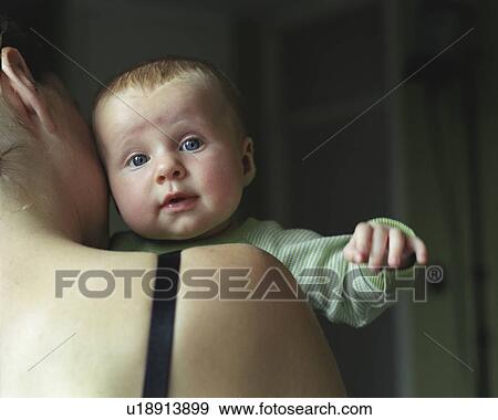 baby looking over mother's shoulder View Large Photo Image Stock Photo - baby looking over mother's shoulder. Fotosearch