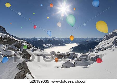 Stock Photography - Ballons flying over winter landscape. Fotosearch