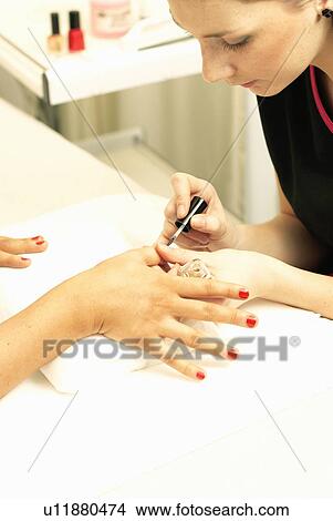 Beautician painting nails View Large Photo Image Picture - Beautician painting nails. Fotosearch