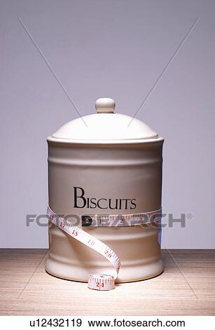 Stock Photo - Biscuit jar with tape measure around it. Fotosearch