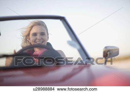 Blond girl driving a cabriolet View Large Photo Image Picture - Blond girl driving a cabriolet. Fotosearch