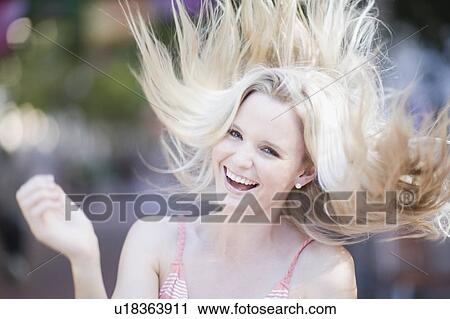Blond girl shaking her hair View Large Photo Image Stock Image - Blond girl shaking her hair. Fotosearch