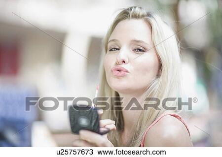 Stock Image - Blond girl with mirror . Fotosearch