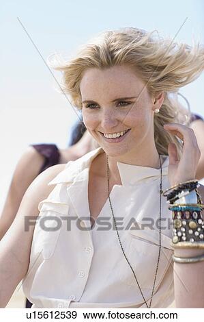 Blond girl with wind in hair View Large Photo Image Stock Photo - Blond girl with wind in hair. Fotosearch