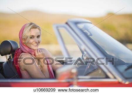 Blond woman with red scarf in cabriolet View Large Photo Image Stock Photo - Blond woman with red scarf in cabriolet. Fotosearch