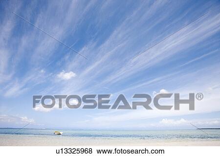 Boat on ocean against blue sky View Large Photo Image Stock Photo - Boat on ocean against blue sky. Fotosearch