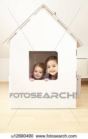 Boy and girl in cardgoard house View Large Photo Image Stock Image - Boy and girl in cardgoard house. Fotosearch