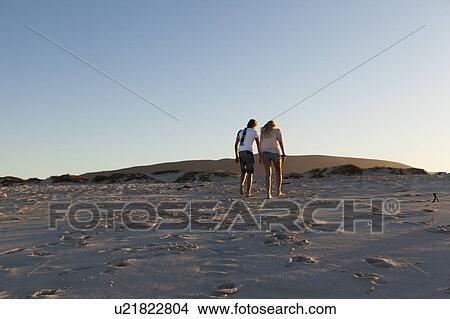 Boy and girl leaving beach View Large Photo Image Picture - Boy and girl leaving beach. Fotosearch