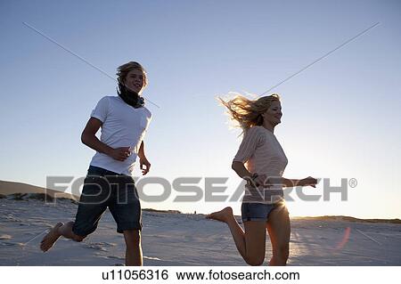 Stock Photograph - Boy and Girl running. Fotosearch