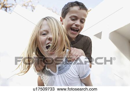 Stock Image - Boy and girl smiling at camera. Fotosearch