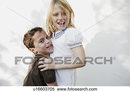 Boy and girl smiling at camera View Large Photo Image Stock Photography - Boy and girl smiling at camera. Fotosearch