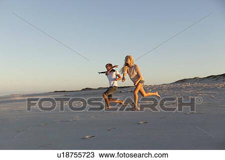 Stock Image - Boy and Girl throwing stones. Fotosearch