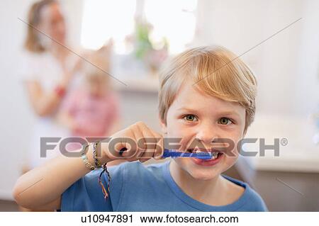 Stock Image - Boy brushing his teeth. Fotosearch