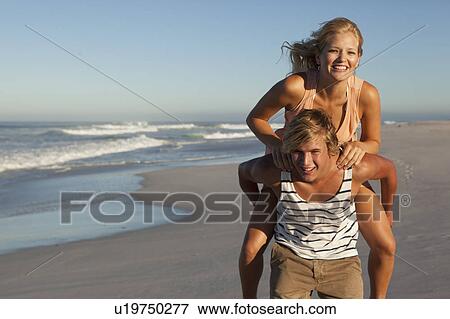 Stock Photo - Boy carrying Girl. Fotosearch