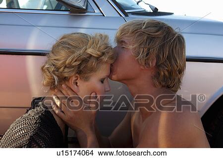 Picture - Boy kissing Girls forhead. Fotosearch