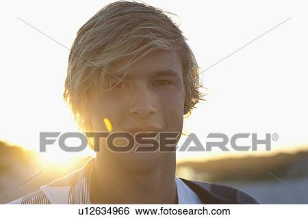Stock Photograph - Boy looking in camera. Fotosearch