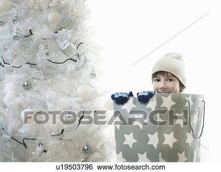 Boy pretending to be a Xmas present View Large Photo Image Stock Photograph - Boy pretending to be a Xmas present. Fotosearch
