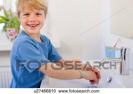 Stock Image - Boy washing his hands. Fotosearch