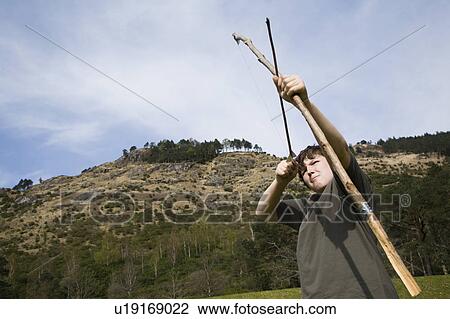 Stock Image - Boy with bow & arrow. Fotosearch
