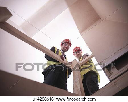 Stock Photograph - Builder and site manager in house. Fotosearch