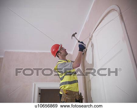 Builder fitting door frame View Large Photo Image Stock Photo - Builder fitting door frame. Fotosearch