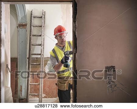 Builder fitting door frame View Large Photo Image Stock Photo - Builder fitting door frame. Fotosearch