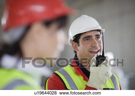 Builder talking in walkie-talkie View Large Photo Image Stock Photo - Builder talking in walkie-talkie. Fotosearch