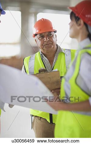 Builder talking to architect View Large Photo Image Stock Photo - Builder talking to architect. Fotosearch