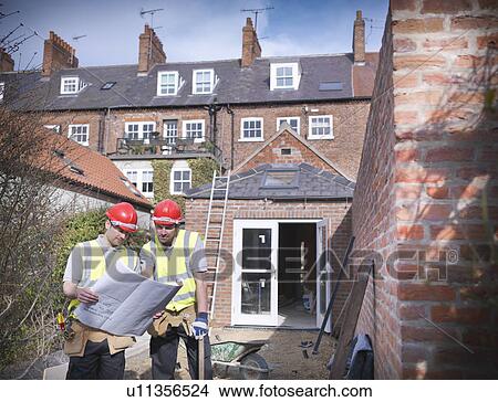 Builders outside house with plans View Large Photo Image Picture - Builders outside house with plans. Fotosearch