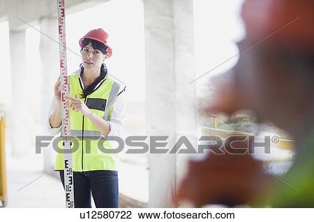 Building worker doing some measurings View Large Photo Image Stock Image - Building worker doing some measurings. Fotosearch