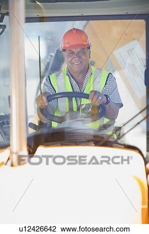 Building worker driving a fork truck View Large Photo Image Stock Image - Building worker driving a fork truck. Fotosearch