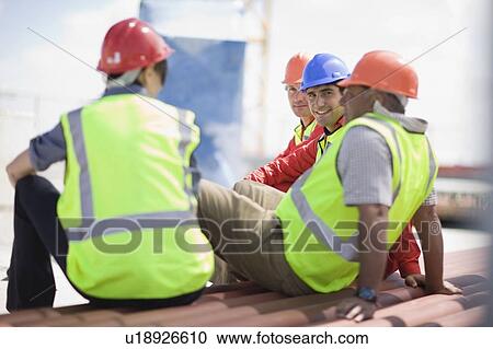 Stock Image - Building workers having a rest. Fotosearch