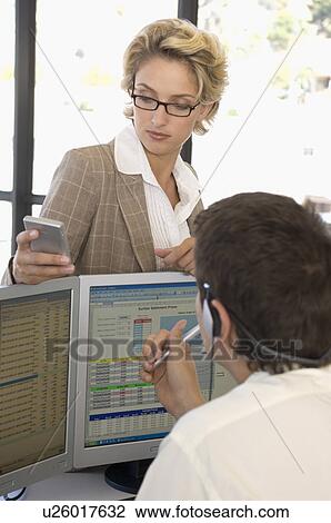 Buiness man and woman at the computer View Large Photo Image Stock Image - Buiness man and woman at the computer. Fotosearch