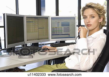 Stock Image - Buisness woman at the computer. Fotosearch