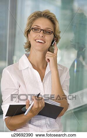 Buisness woman smiling on the phone View Large Photo Image Stock Image - Buisness woman smiling on the phone. Fotosearch