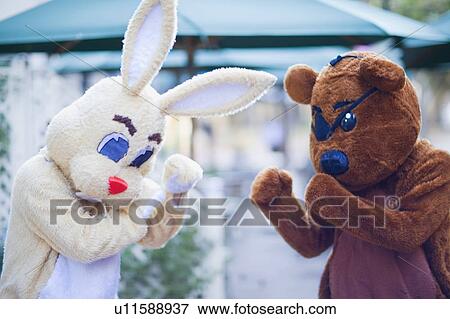 Stock Photo - Bunny and bear having a fight. Fotosearch