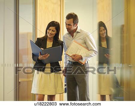 Stock Image - Business couple chatting. Fotosearch