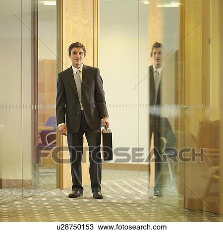 Stock Image - Business executive with briefcase. Fotosearch