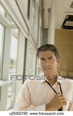 Business man adjusting his tie View Large Photo Image Stock Image - Business man adjusting his tie. Fotosearch