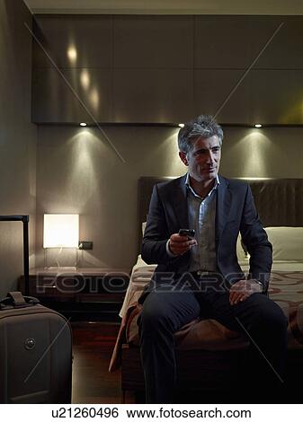 Business man in his hotel room View Large Photo Image Stock Photograph - Business man in his hotel room. Fotosearch